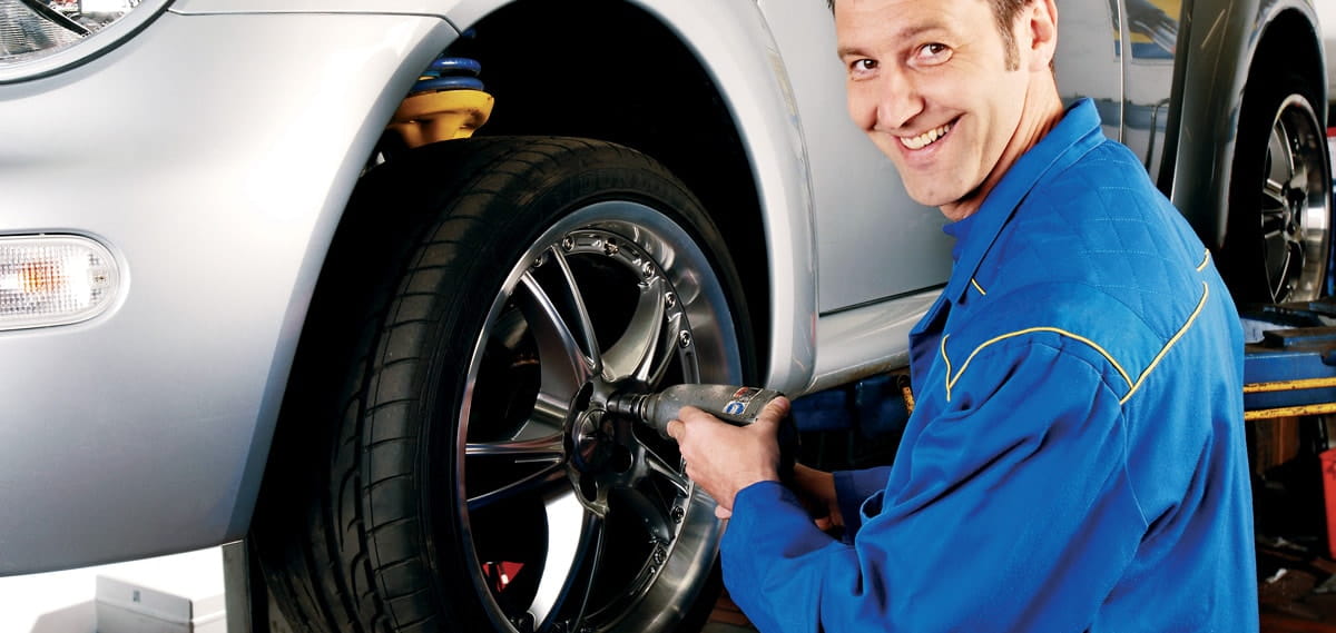 trained professional installing tire